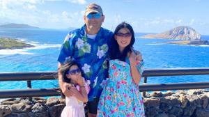 Dad with two daughters with beautiful ocean in background