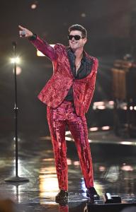 Singer Robin Thicke shines in a vibrant red suit as he pays tribute to Bobby Caldwell during his captivating performance at the 8th Annual Black Music Honors