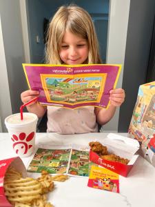 Girl with Upbounders Prize Enjoying Diverse Fun with Chick-fil-A Kid's Meal
