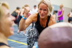 Woman at fitness conference having fun with a friend.