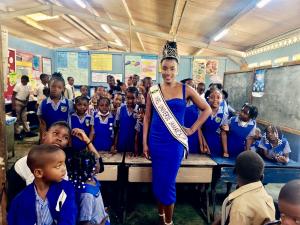 Mrs.Universe Jamaica 2022-Oliva Smikle Pageant Queen takes Picture with children.