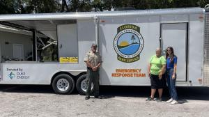 Representatives from Florida State Parks and Duke Energy Florida celebrate a new strike team trailer provided through the Duke Energy Foundation.