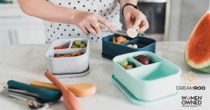 Woman meal prepping with Dreamroo bento boxes for sustainable and organized meals.