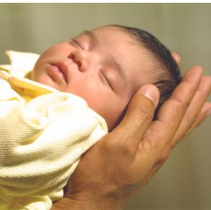 A Safe Haven for Newborns infant sleeping peacefully in caring arms.