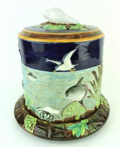 George Jones & Sons majolica cobalt-blue and turquoise-ground 'Sea and Sky' cheese keeper and stand, circa 1878, cylindrical, with conch shell and seaweed knob (est. $12,000-$15,000).