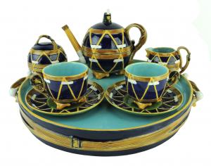 George Jones "Drum" cabaret set, circa 1875, designed as cobalt blue drums, with yellow skin tightening string, the teapot with drumsticks forming the spout (est. $12,000-$15,000).