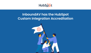 Animated characters holding flag with HubSpot Custom Integration Accreditation logo.