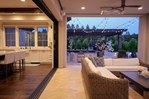 indoor outdoor space where an outdoor furniture set is surrounded by a pool and cook center