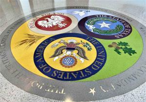 Terrazzo medallion in the Polish Heritage Center features the seals of Texas, Poland, and the United States.