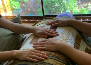 Reiki practitioners giving Reiki to a person