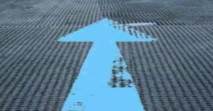 Wide blue arrow pointing forward across a field symbolizing the path forward.