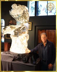 Mark Russo standing by the side of Belvedere Torso Sculpture in Pure Silver