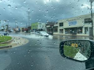 Image of cars driving through floods on York Road.
