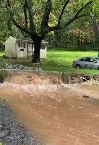 Image of water flowing over a stone wall down a driveway