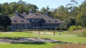 Chasing Dreams Down the Fairway: A stunning view of Tidewater Golf Club's 18th hole, where memories meet the clubhouse backdrop.