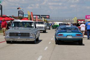 Vintage cars and trucks cruising.