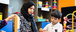 BISEE teacher with student working one on one