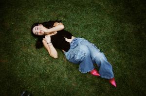 Adeline V. Lopez lies on grass in the park
