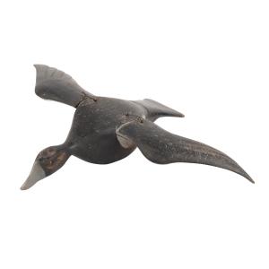 Painted softwood stick-up model flying snow goose blue phase hunting decoy used on the shores of the St. Lawrence River, 5 ¼ inches tall with an impressive 28-inch wingspan (CA$8,850).