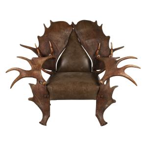 Unusual, circa 1900 Canadian armchair constructed from moose antlers, with a deep upholstered seat and back, the antlers forming the legs, arms, and wings of the back (CA$7,080).