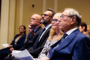 Professor Irwin Cotler, Dr. Katrina Lantos Swett, Ambassador Roger Carstens and Rep. Jim McGovern watch a video at the 2023 Lantos Prize ceremony