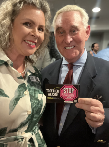 Roger Stone, Political Adviser to 45th President Donald Trump holds "Stop The Government Gangsters Vote Christi Tasker" sticker with Christi Tasker
