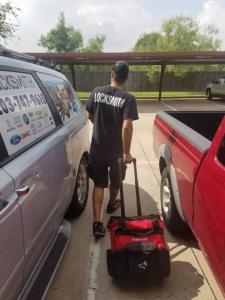 Locksmith technician next to our company vehicle