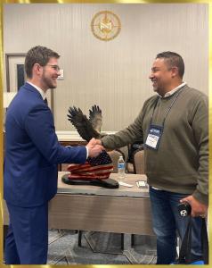 Picture of Director of Operations Ricky Reed Congratulating New Ghiglieri Collector