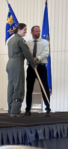 A man, Mike Wall, being presented an award at Air Force base