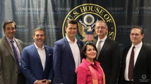 Speakers at Quantum Space Collaboration Press Event standing in front of the blue United States of America, House of Representatives background with Matt Cartwright's name. . From left to right: Dr. Max Perez of Infleqtion, Michael Bloxton, Co-Founder of 