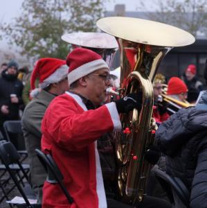 Performers playing tuba in the Big Christmas Wind Orchestra and Choir 2022 performance at Kings Cross