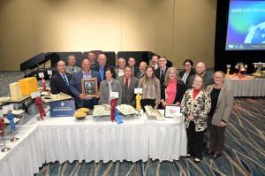 Prairie Farms' CEO, board of directors, and dairy farmers  pose for a photo with winning cheeses