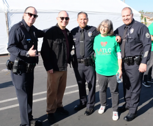 The Executive Director of LATLC, Lissa Zanville, with LAPD officers at the "Comfort & Joy" Event in LA.