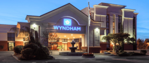 exterior of the front entrance of Wyndham Visalia at night with all the lights on