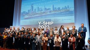 The words "Y-SHIP 2023" superimposed over an image of representatives on stage from 43 different cities and organizations that joined the Yokohama Declaraction during the convention.