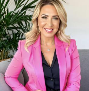 Bianca McNamara is pictured in a pink blazer posing for retail security services