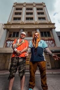 Los Chicos Criollos profile image standing in front of the Commonwealth building in Miami, FL