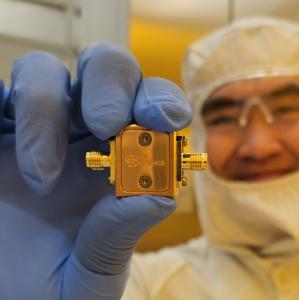 Research Engineer holding QiB0 Quantum Device