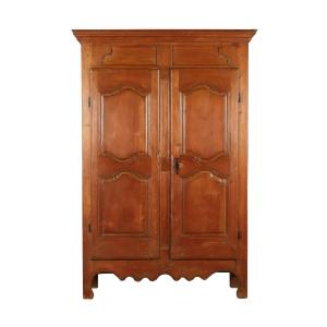 18th century Quebec armoire with a high double-paneled frieze and cabriole feet, refinished in the 1950s, boasting a warm pine patina and robust construction (est. CA$20,000-$30,000).