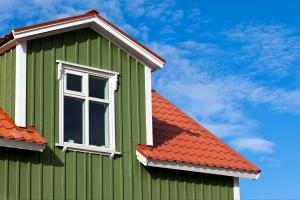 Roof and side of a home with a clear sky in the background