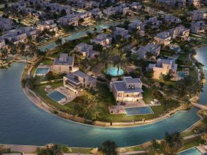 Aerial view of villas at Oasis by Emaar community with crystal lagoons and palm trees