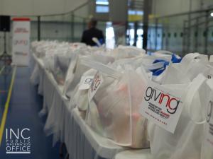 Care packages with the INC Giving logo, lined up for distribution at the Bob Snodgrass Recreation Complex