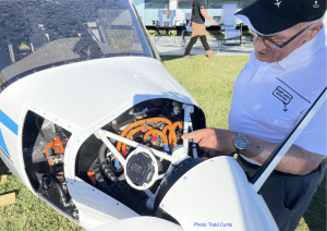 John Goglia examines an electric engine on an airplane