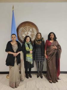 AMMWEC women leaders (from left to right)Farhana Khorshed, Zeba Zebunessa, Anila Ali, and Soraya Deen at the UN standing in front of the UN flag and logo