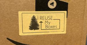 Image of a sticker that says "I Reuse My Boxes" affixed to a shipping box