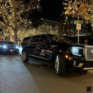 Avo Limo SUV Denali on cherry creek srteet lined with lighted trees