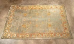 Antique, palace-size, hand-knotted, wool-on-wool Turkish Oushak rug, having gold, tangerine and cream palmettes and flowers on a sage green field, 23 feet by 14 feet 5 inches (est. $10,000-$20,000).