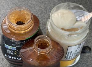 Manuka honey (bottom): the crystallization shows signs of aging and detioriation. Organic "wildflower" honey (top left). Fresh soft-set raw honey - likely your healthiest choice