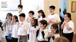 A group of young INC volunteers singing at Grass Home Long Term Care Home