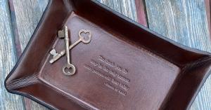 A leather Tray embossed with a quotation from Saint Francis of Assisi